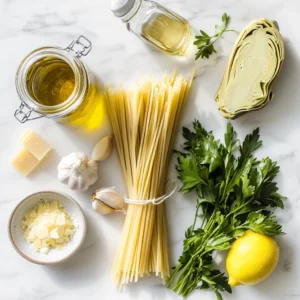 Essential ingredients for creamy artichoke linguine laid out on a marble countertop, including linguine, artichokes, parmesan, garlic, and olive oil.